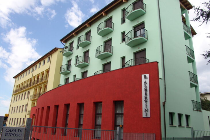 Facciata esterna della Casa di Riposo con edificio multipiano, balconi, ingresso e insegna della struttura.